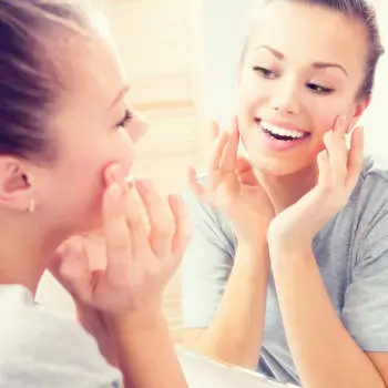 joyful woman is looking at the mirror