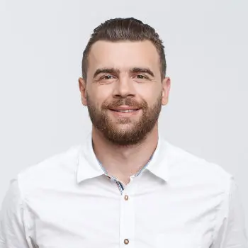 young man with beard is smiling