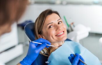 A woman has an annual dental check-up in dentist surgery.